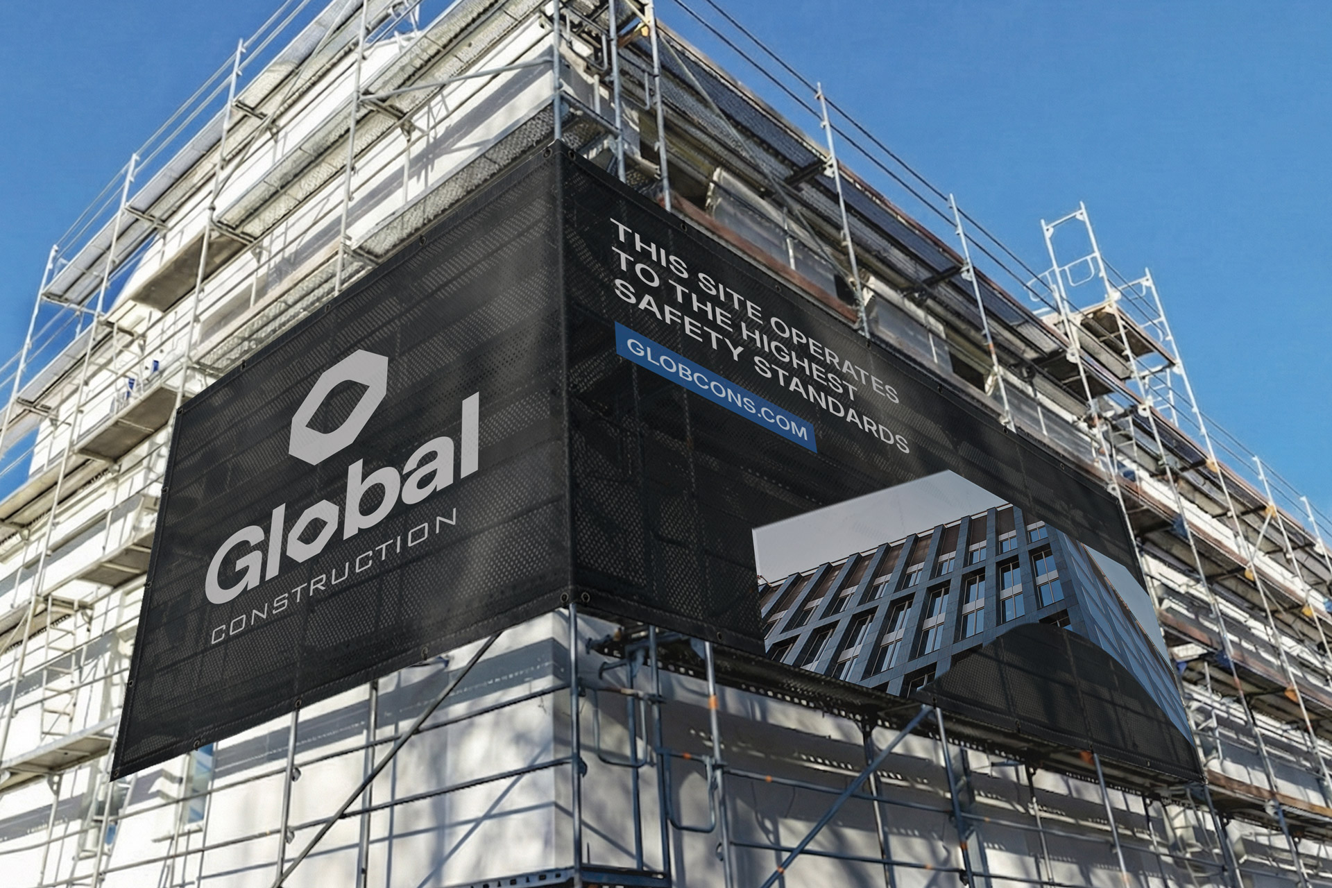Global Construction black mesh banner on the building facade