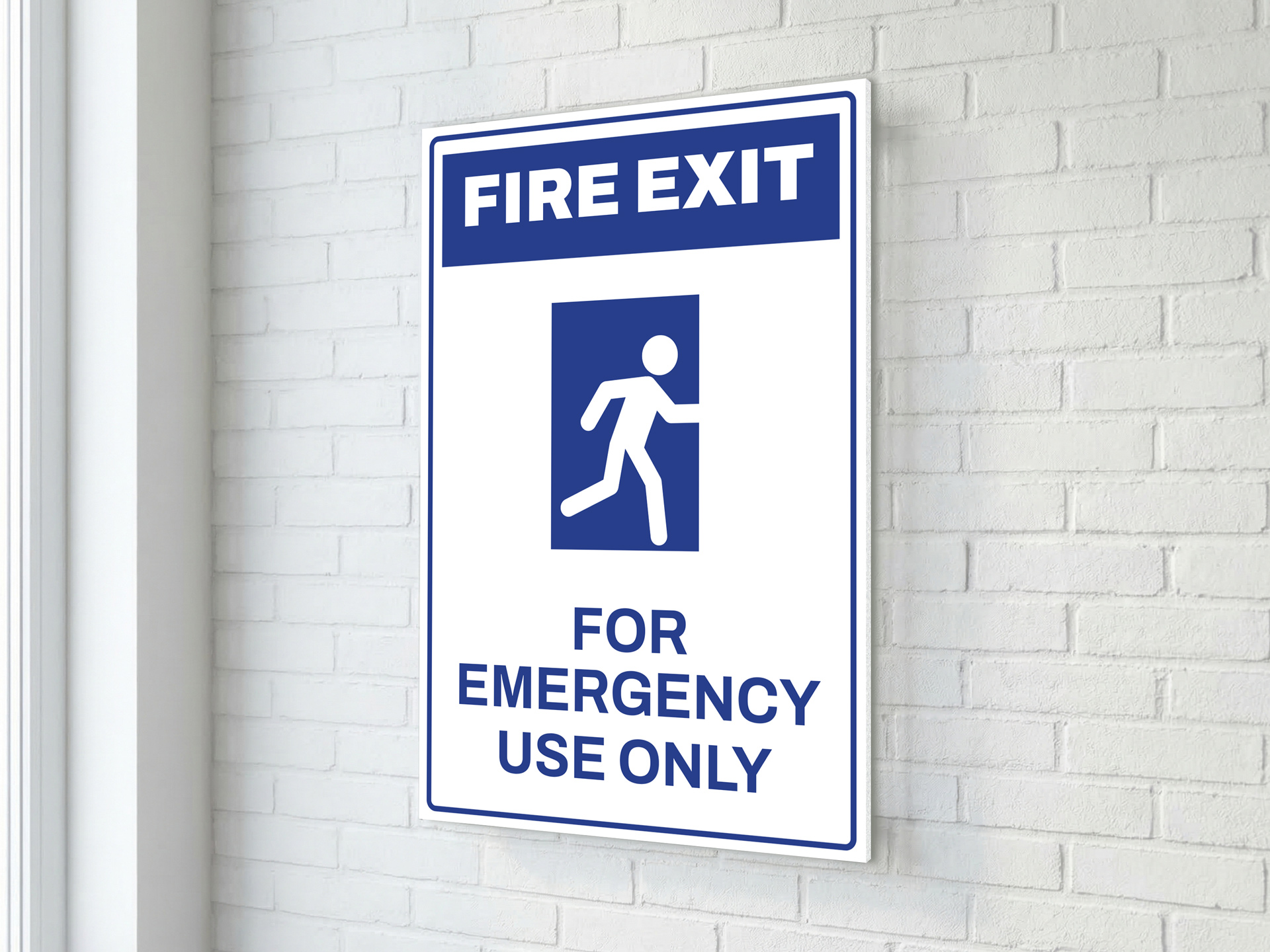 pvc fire exit sign on a brick wall
