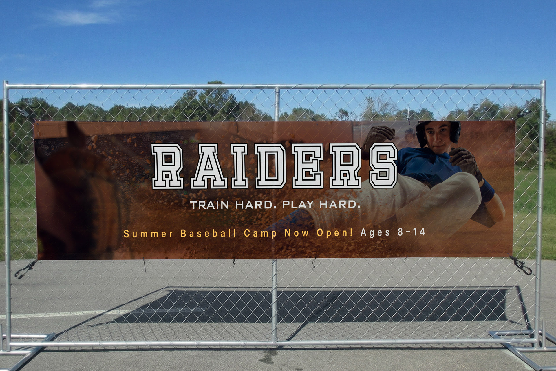 Sporting event mesh banner featuring the team's name and slogan, attached to the fence