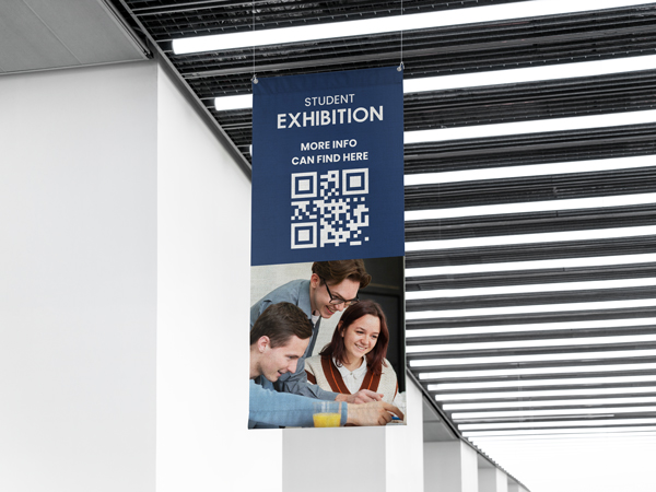 Student exhibition rolled canvas prints with QR code hanging in modern building.
