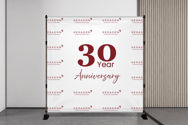 A red and white step and repeat banner for a company's 30th anniversary.