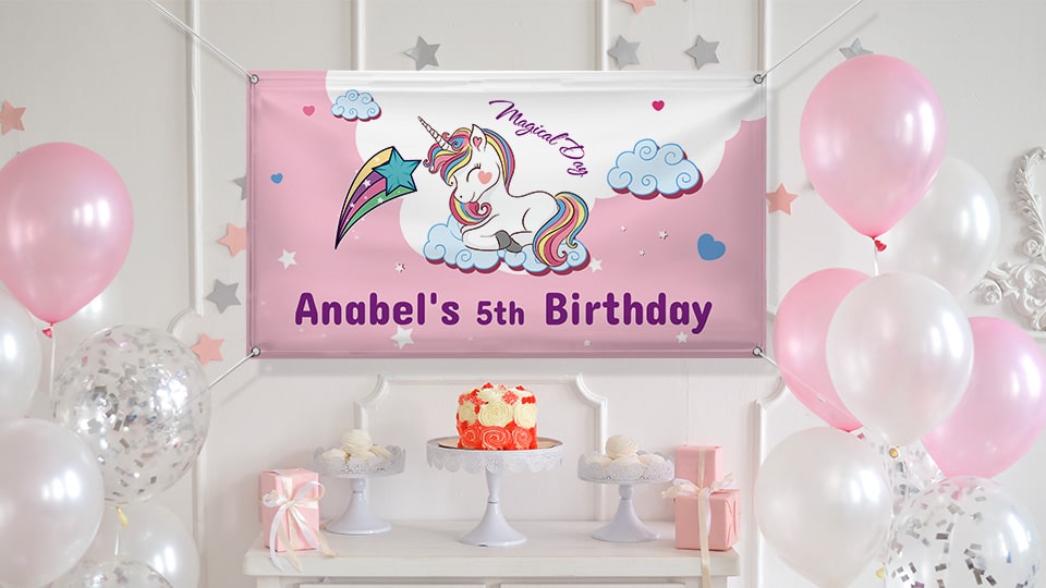 5th birthday banner in pink portraying a cute unicorn hung over the birthday cake table.