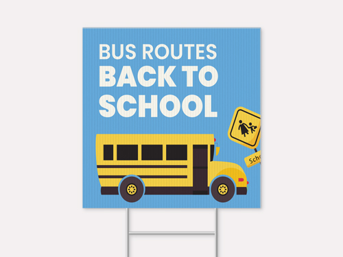 Bus routes back to school sign with yellow school bus and crossing signs.