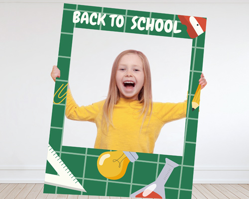 Fun back to school banner frame with excited young girl in yellow shirt posing.