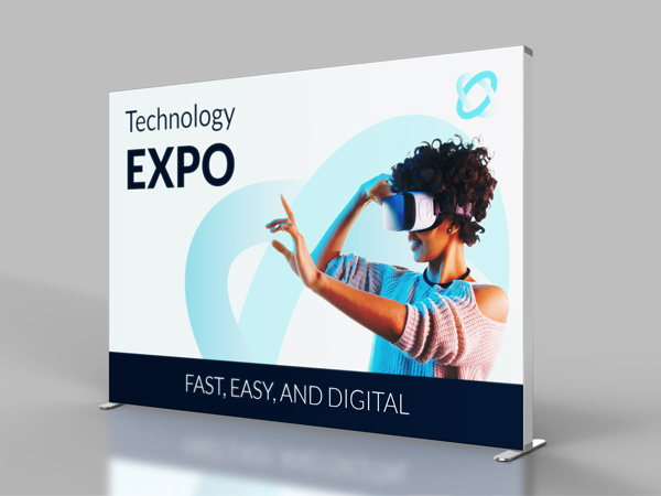 Backlit SEG fabric display for a technology expo featuring an image of a woman wearing a VR headset.