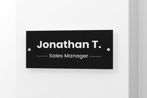 Sales manager acrylic nameplate reading Jonathan T. Rasheed in black on a white background