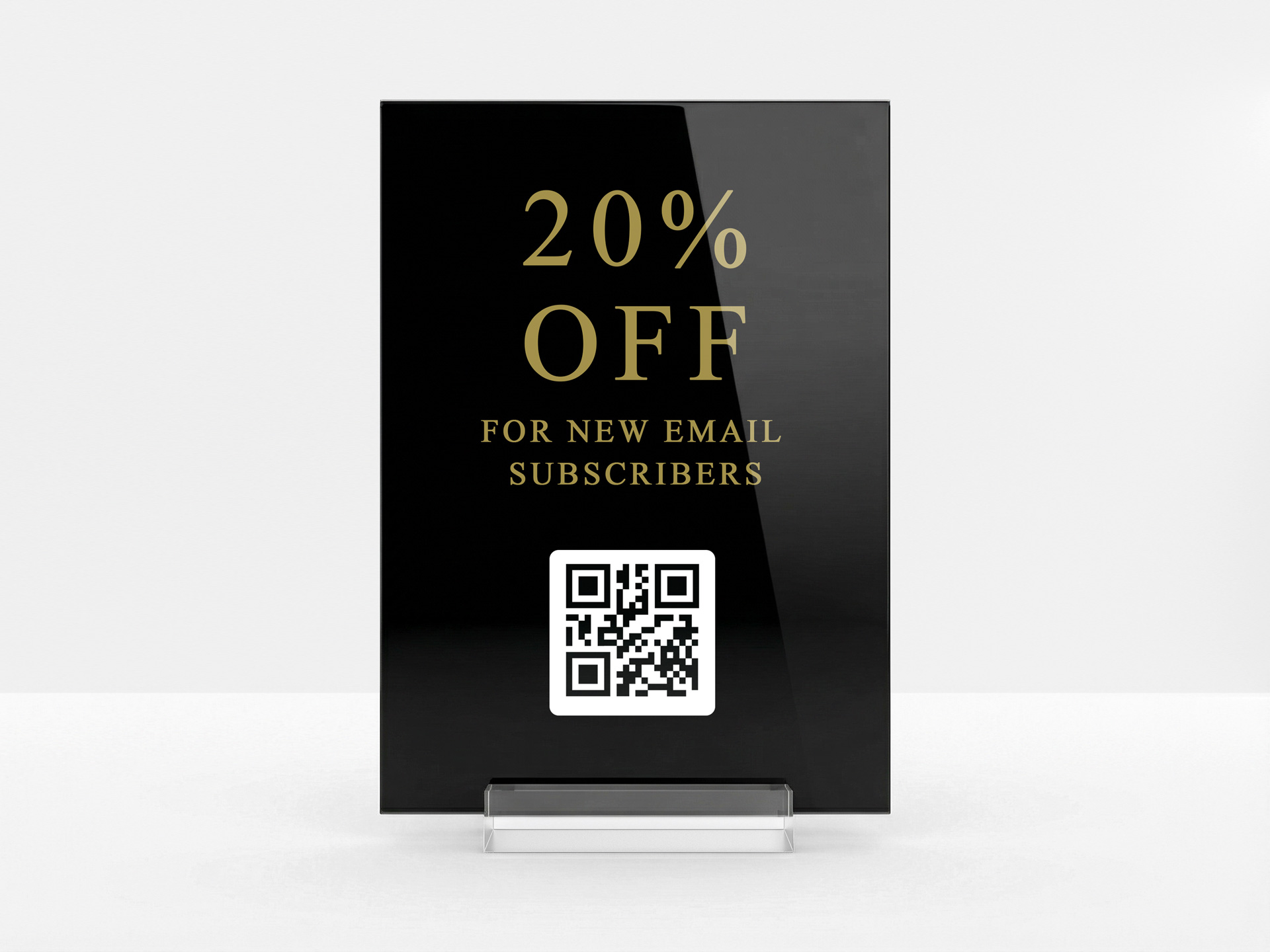 Black acrylic table sign promoting a discount for new subscribers.
