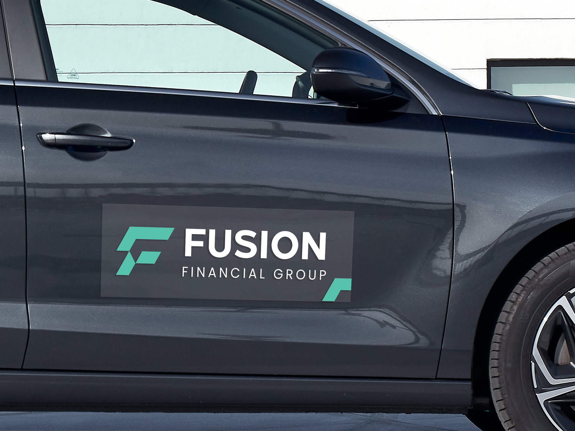 A branding car decal on the car door reading Fusion Financial Group.
