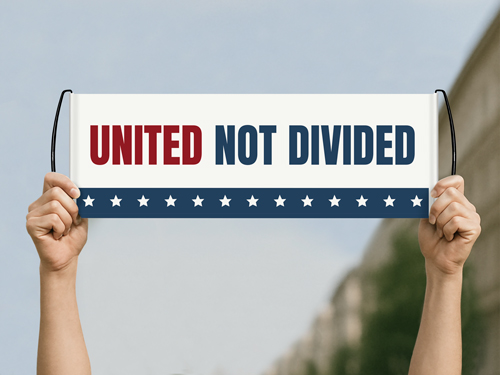 A white, blue, and red hand banner held up at a political rally reading the words United not Divided.