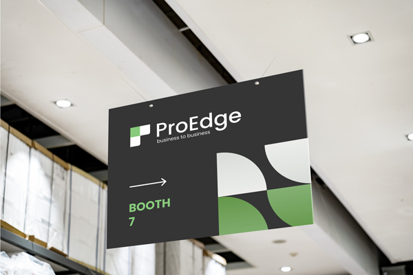 An expo PVC sign hanging from the ceiling and showing the way to a company's booth.