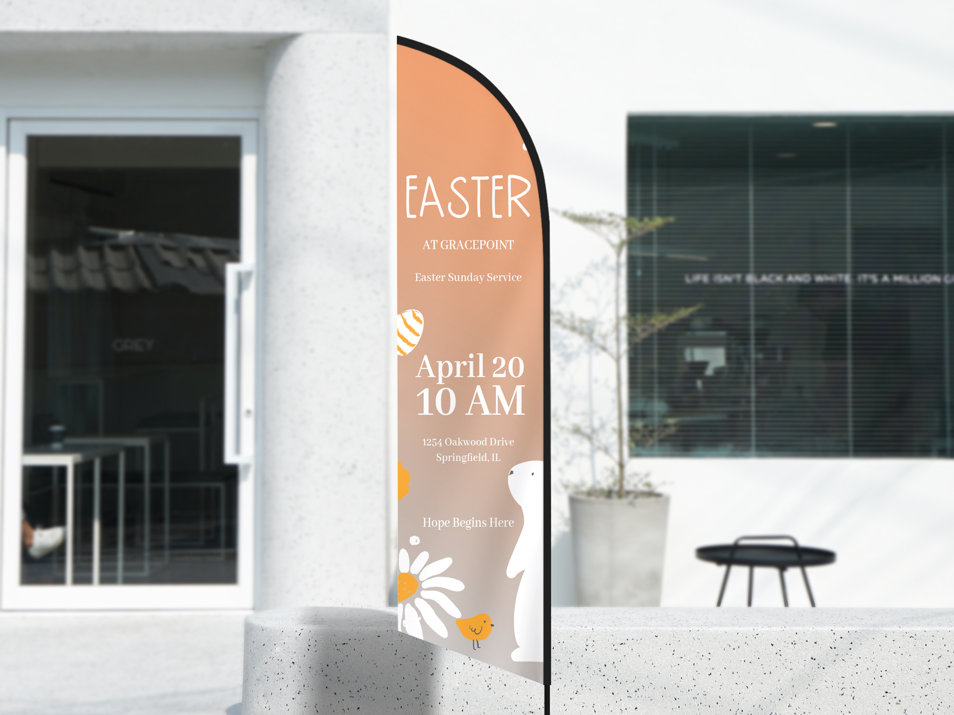 Easter church feather flag sign in festive decorations featuring the event date.