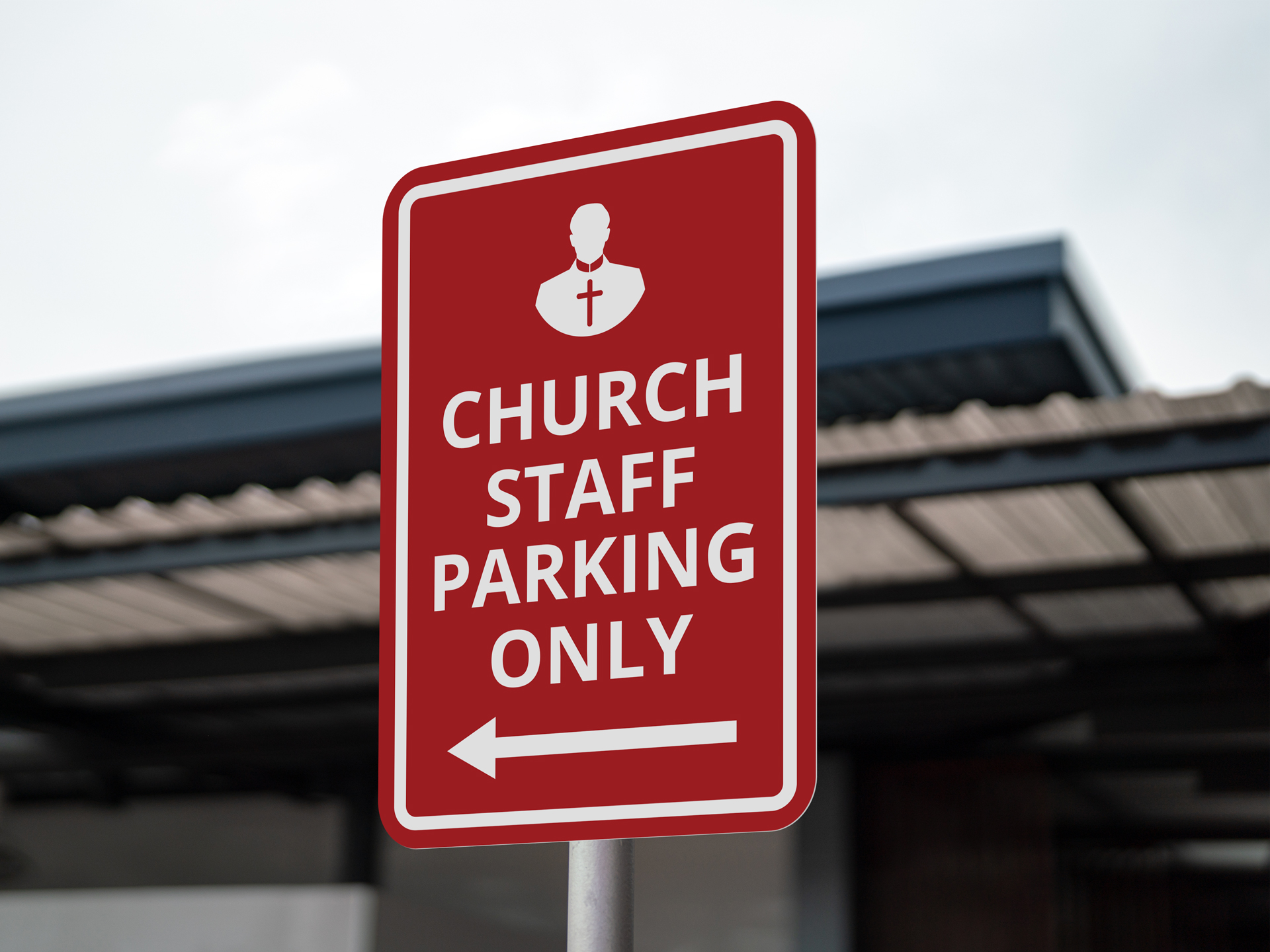 Red church parking signage reading Church Staff Parking Only.
