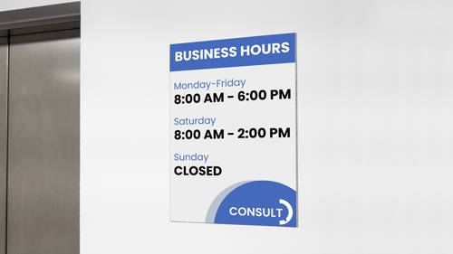 A gatorboard sign mounted on the wall showcasing a company's working hours.