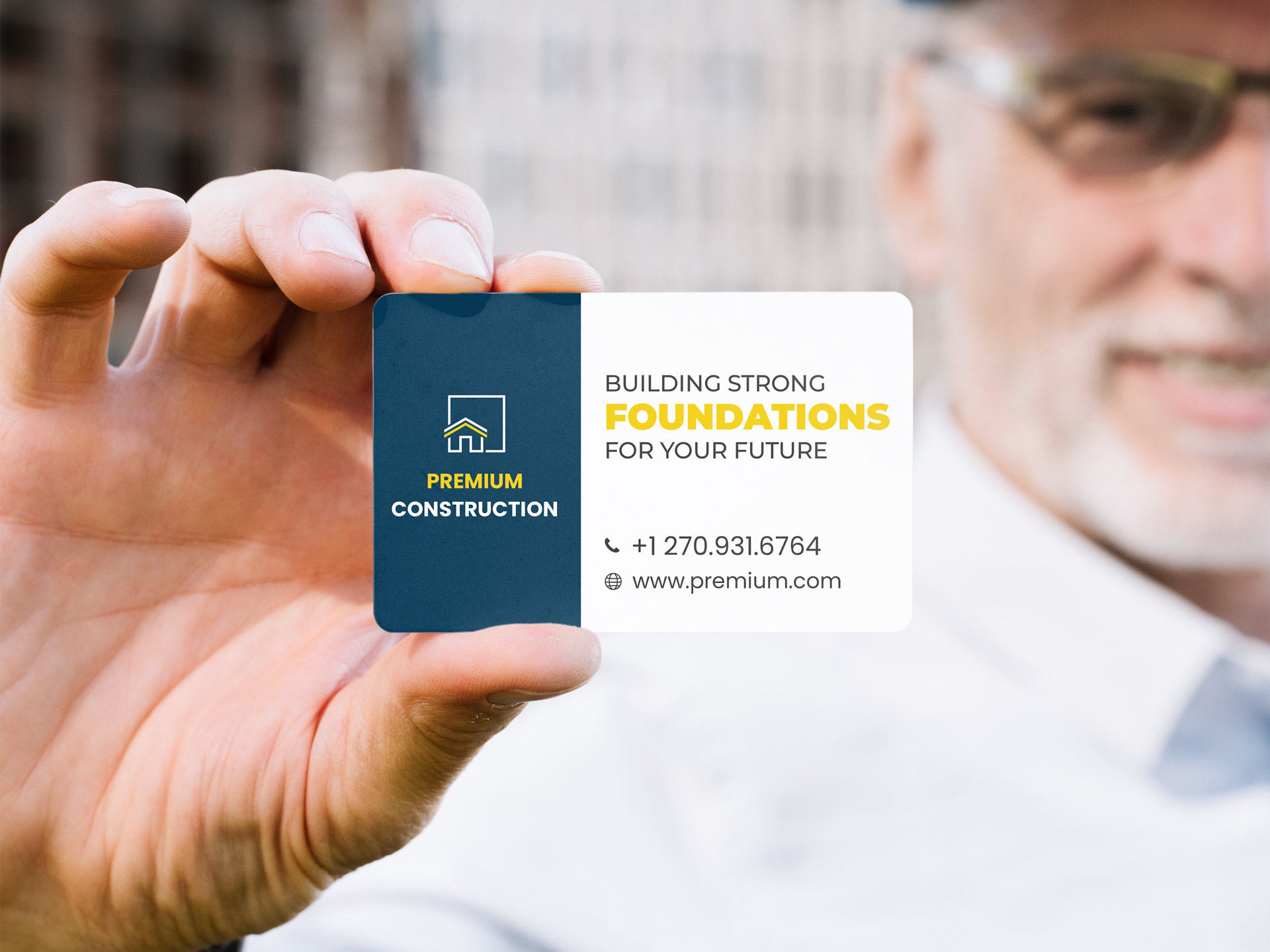 An image of a man holding a construction company business card.