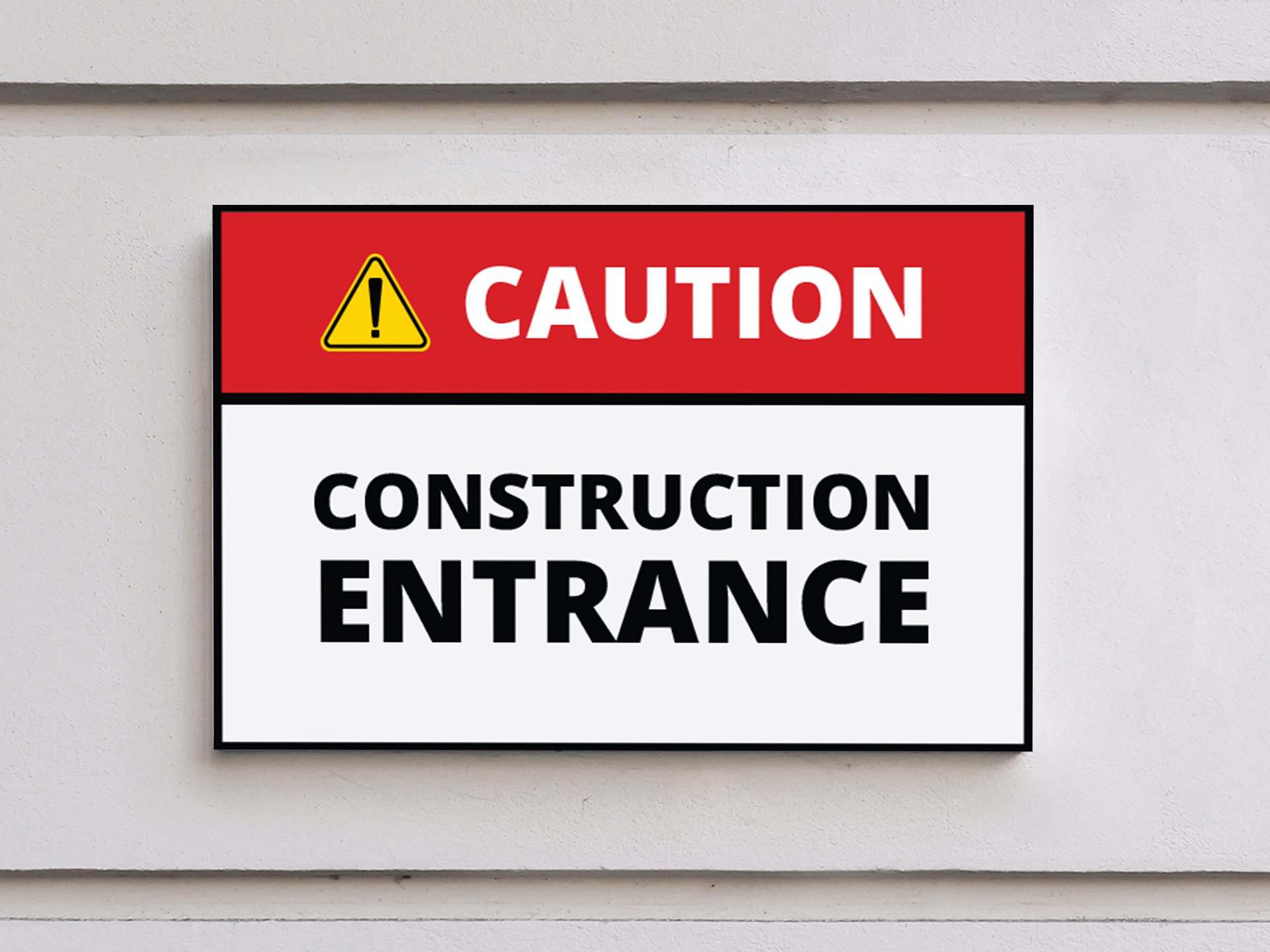 A red, black and white construction entrance caution sign.