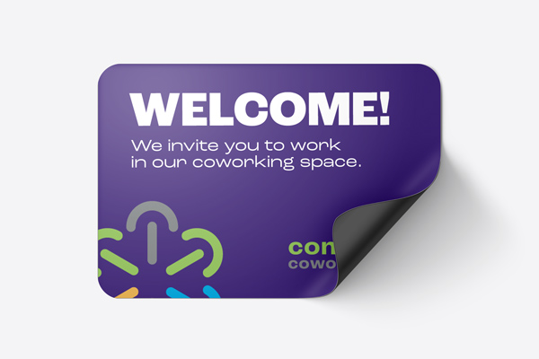 A purple magnetic sign for a coworking venue inviting people to work from there.