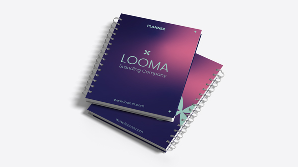 Dark-colored company branded custom planners with white and gold spiral binding.