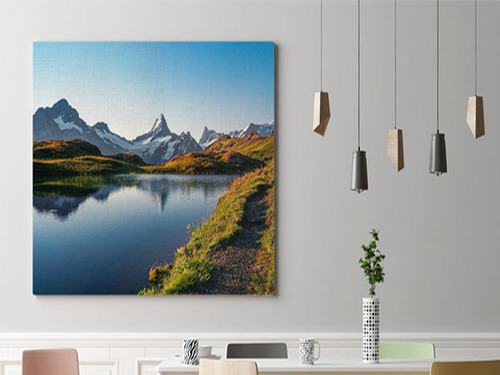 Large canvas prints with mountain landscape with peaks reflecting in calm blue lake.
