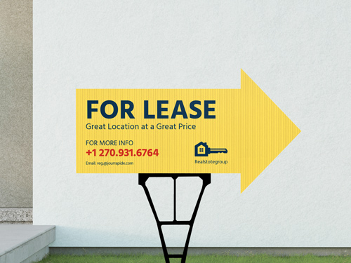 A yellow For Lease yard sign set up in front of a property.