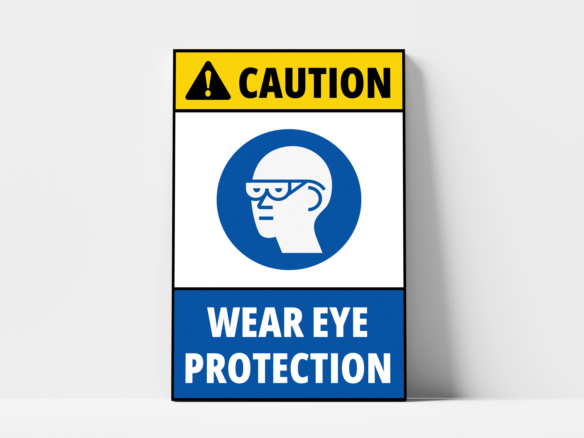 Caution sign requiring eye protection in work area.