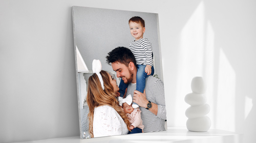 A gator board sign showcasing an image of a family made up of a mother, father, and child.