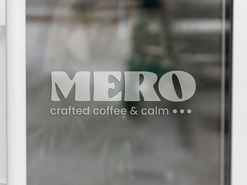 Frosted vinyl lettering reading Mero, Crafted Coffee and Calm.