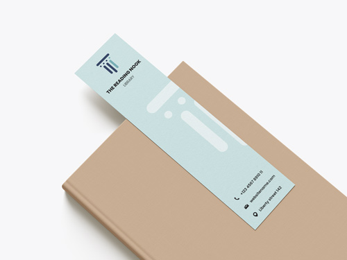 Light blue library bookmark with logo, contacts, and modern design placed on a beige book.