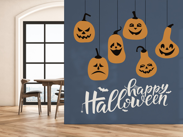 A halloween-themed wall decal with hanging pumpkins and a text that reads Happy Halloween underneath.