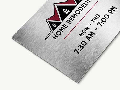 Gray brushed aluminum sign featuring a house and reading home remodeling