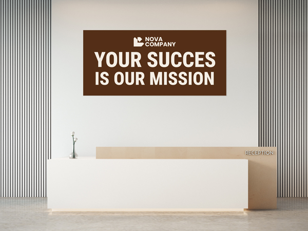 A brown and white wall decal adhered to the wall behind an office reception desk with a motivational quote.