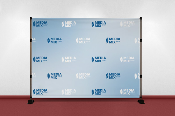 A light blue media event backdrop placed on a red carpet showcasing the media brand's name and logo.