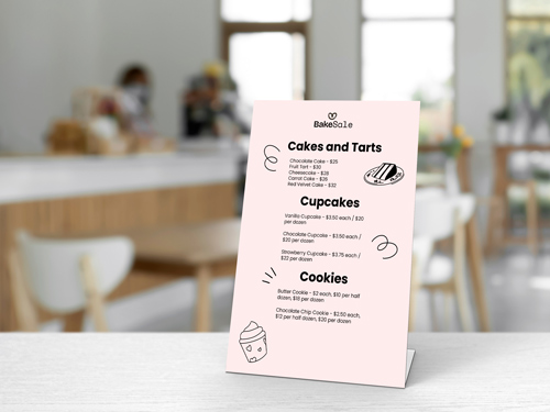 Café menu with cakes, tarts, cupcakes, and cookies, adorned with small decorations and prices.