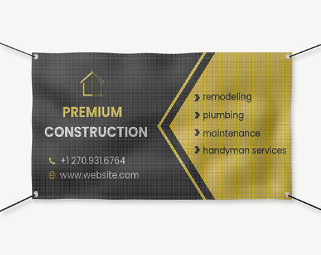Yellow and black hanging mesh banner reading premium construction
