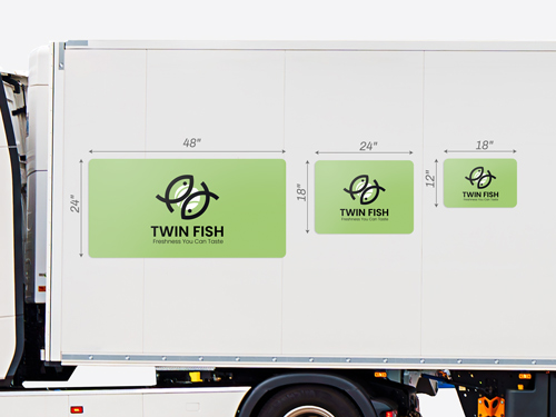 Vehicle magnets shown attached to the side of a trailer to compare the different sizes of the product.
