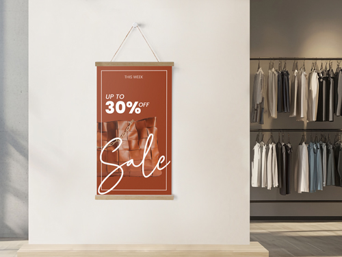 Retail sale poster in magnetic wood frame hanger on boutique wall