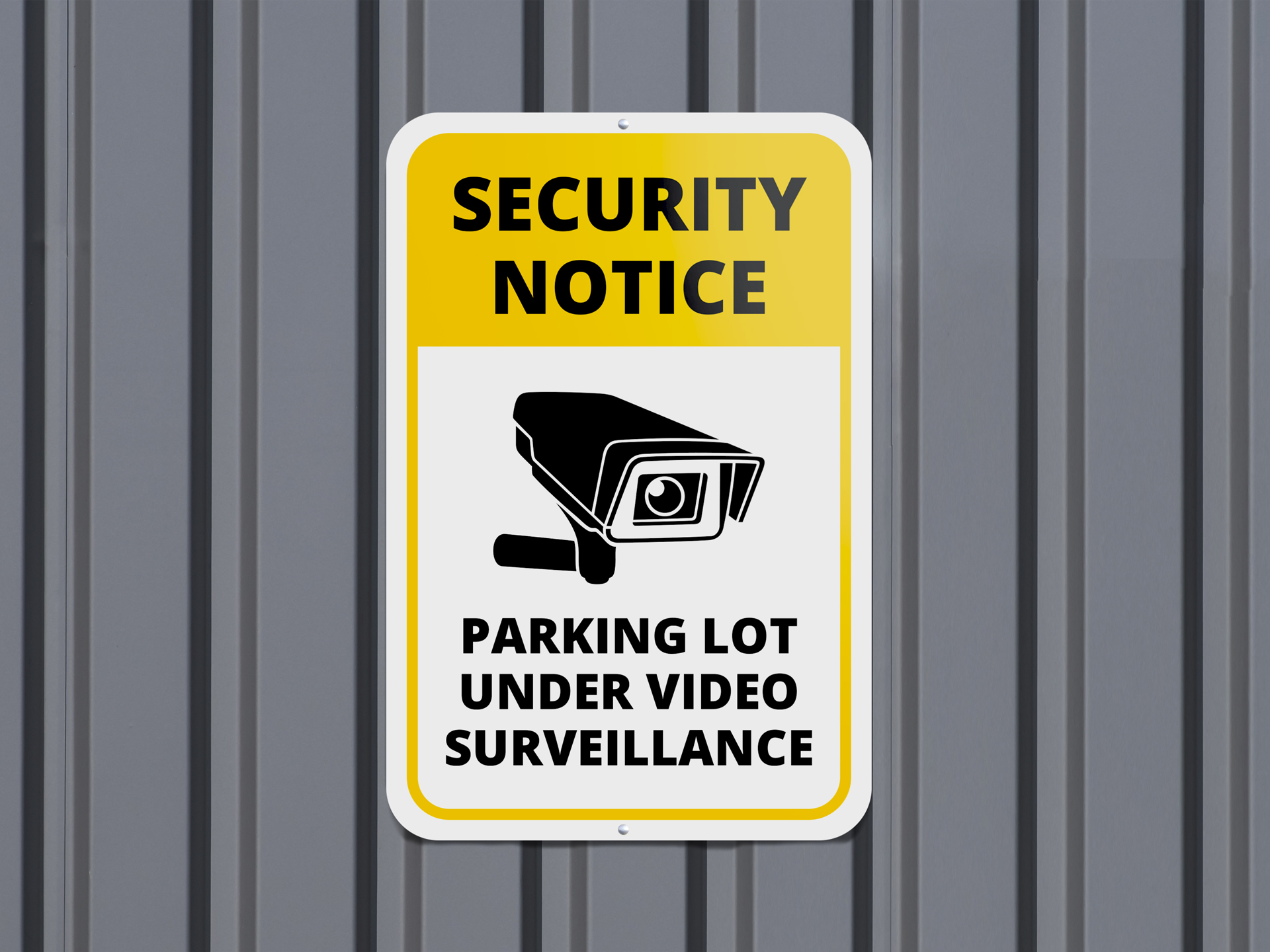 A wall-mounted parking lot sign with a security notice illustrates a camera and reads "Parking Lot Under Video Surveillance"