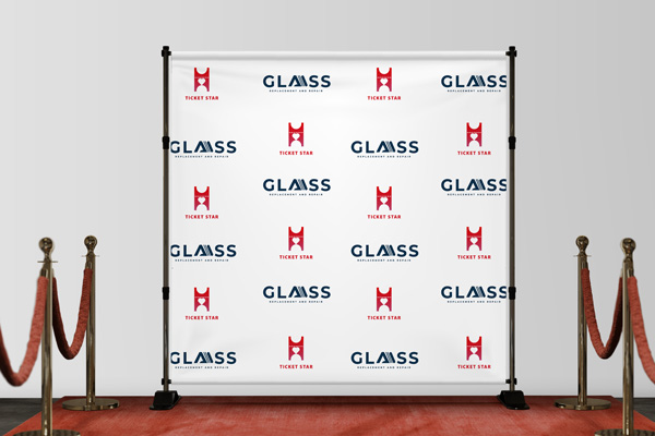 A red carpet step and repeat banner with the logos of the event's sponsors.