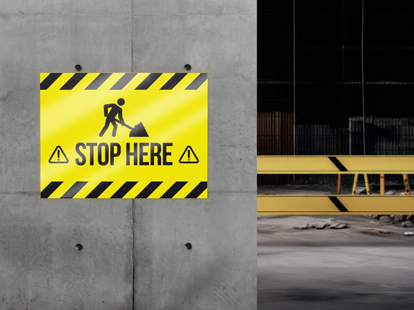 A warning reflective coroplast sign reading Stop Here for construction sites.