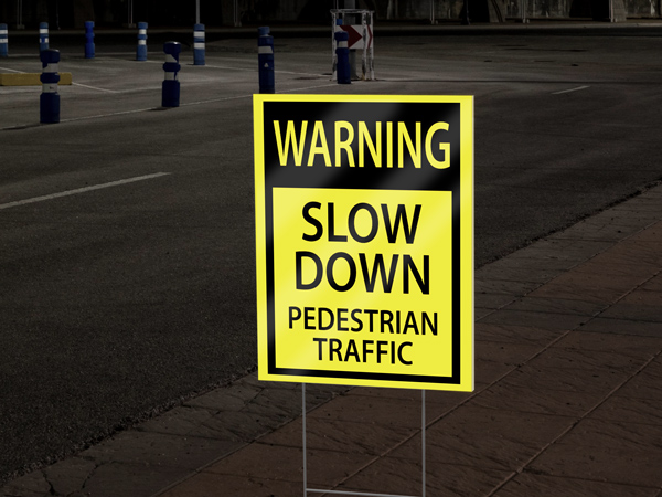 Yellow reflective coroplast sign with a warning message.