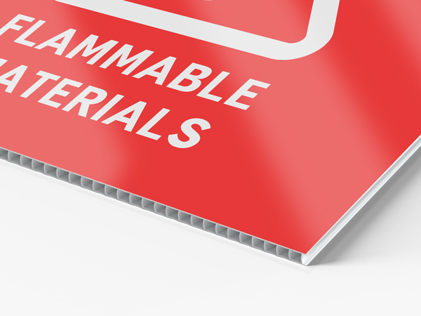 Red reflective coroplast sign reading flammable materials.