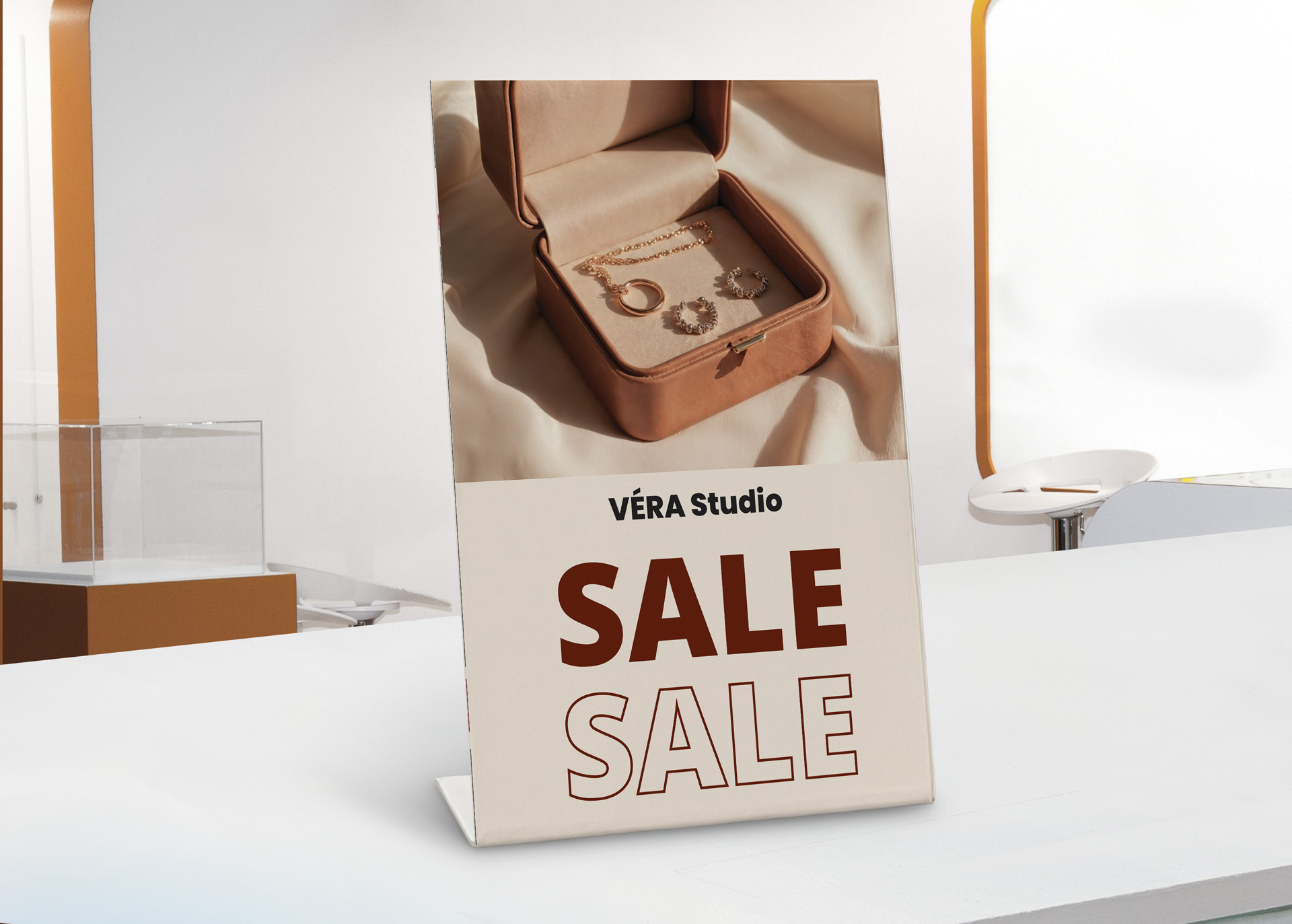 Véra Studio sale table sign featuring jewelry box on retail store counter display.