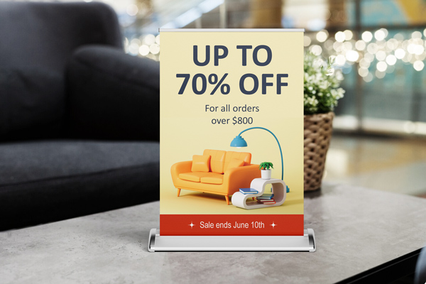 Promotional tabletop retractable banner for a shopping center announcing up to 70% deal.