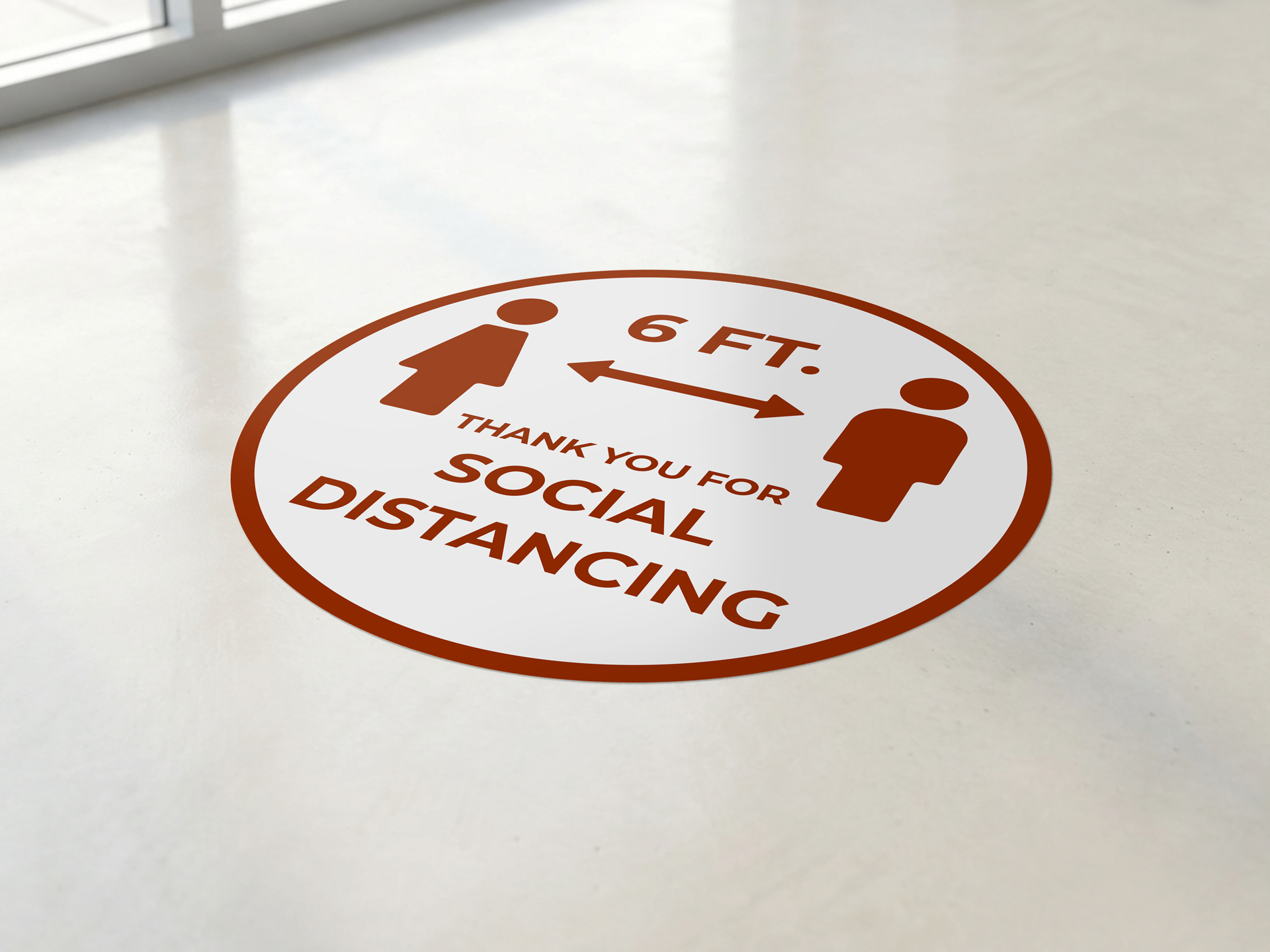 A red and white round floor decal thanking people for social distancing.