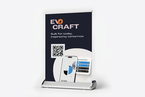 A tabletop retractable banner featuring a QR code and a mobile app design.