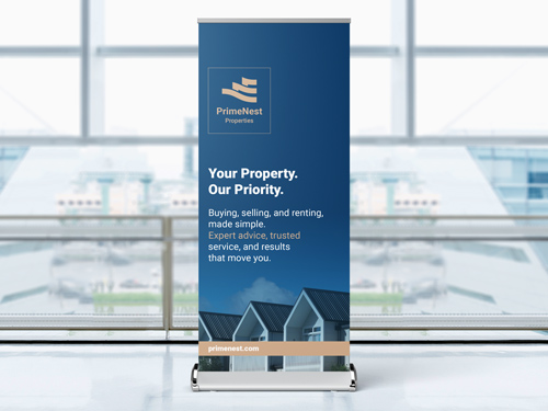 Real estate trade show retractable display for PrimeNest Properties with tagline and house image.