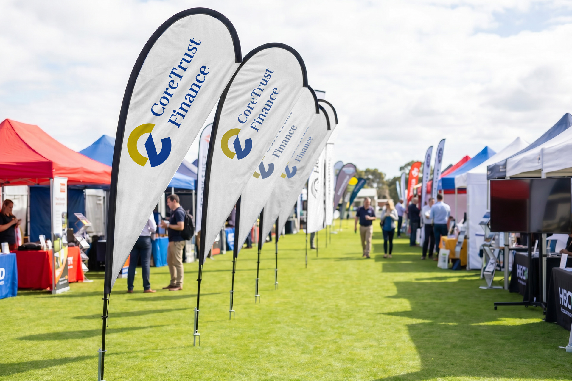 custom printed teardrop flags installed in a row for an outside event