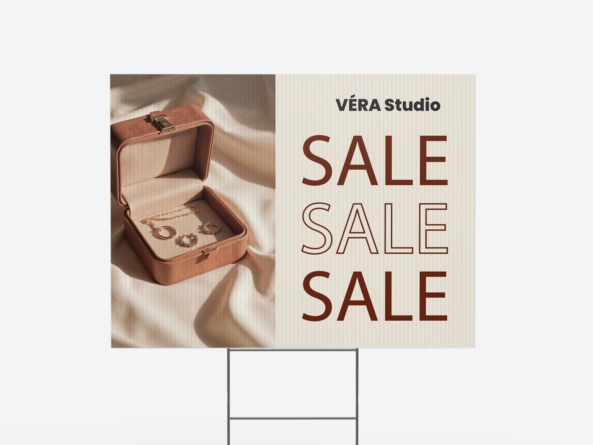 Retail yard sign promoting Vera Studio jewelry sale with product display.