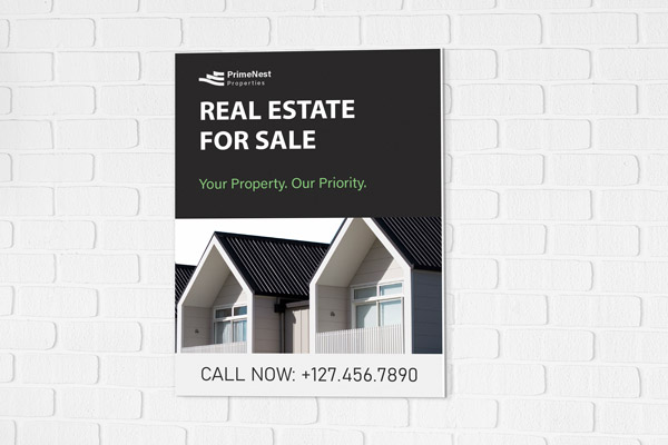 A black real estate for sale PVC sign that contains directions, contact information, and an image of houses.