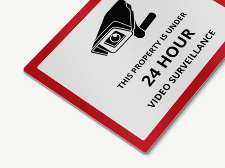 Property surveillance warning aluminum sign featuring a camera