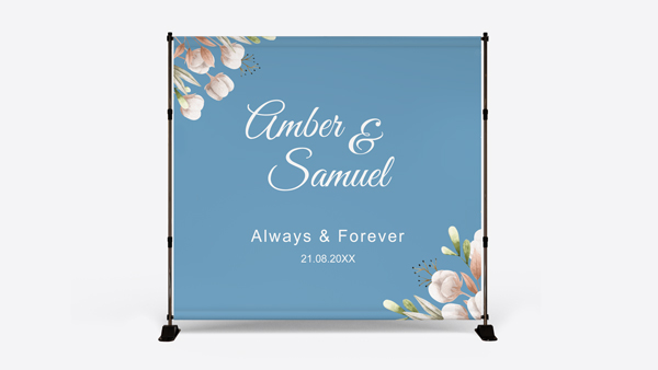 Blue wedding backdrop with floral corners featuring Amber & Samuel Always and Forever.